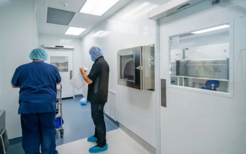 Technician changing filters in a cleanroom